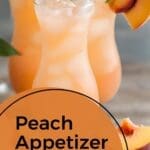 The image shows a glass of peach juice with a slice of peach on top of it.