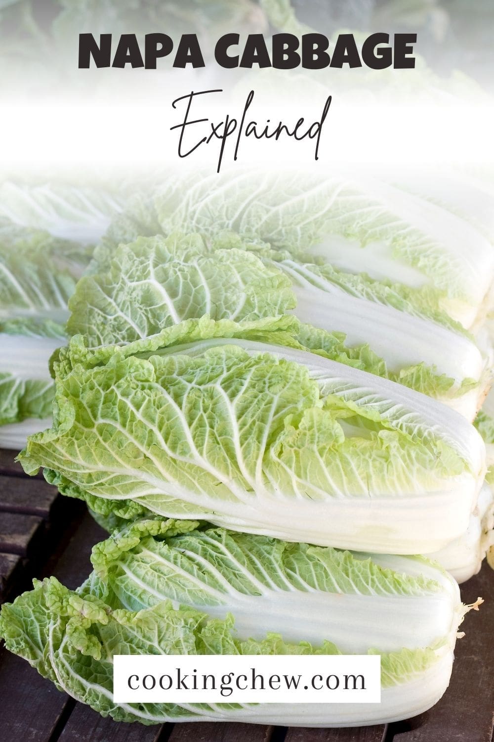A photo of a stack of napa cabbage on a wooden table.